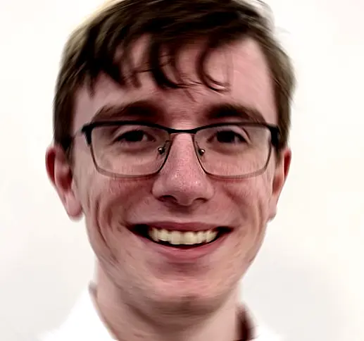 Luke's face - a friendly young man with glasses and brown hair